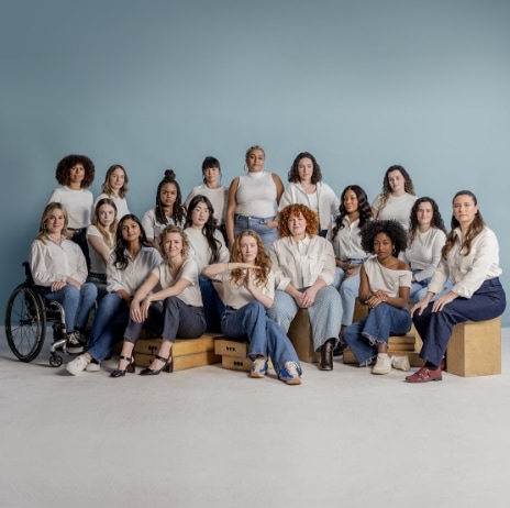 A woman smiling while looking at her mobile